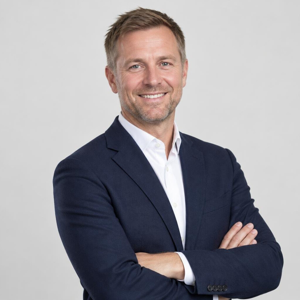 Portrait of a smiling man in a suit with a light background